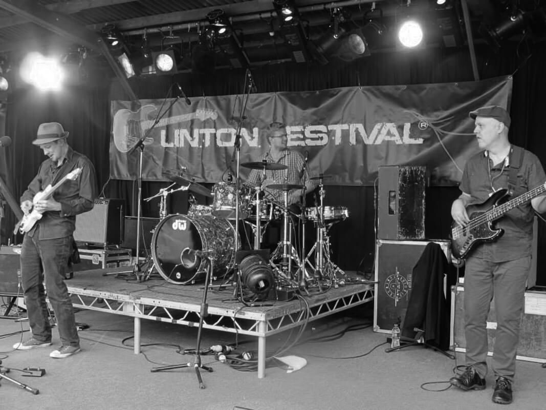 Monochrome photo of Matt Hartnell drumming at Linton Festival